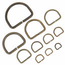 Anneau demi-rond en acier avec finition laiton vieilli, bouclerie artisanale pour création de bijoux.