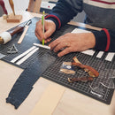 Formation Deco Cuir pour fabriquer un bracelet de montre en cuir, image d'un atelier intermédiaire, outils et bracelet en cuir visible