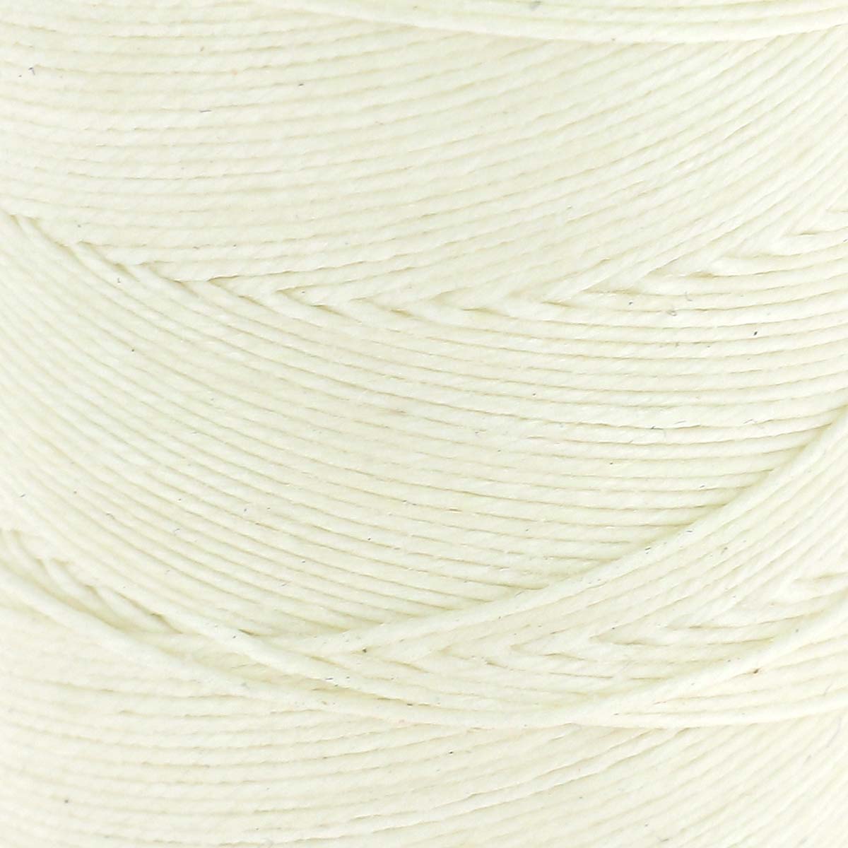 Bobine de fil de lin poissé naturel de la marque Campbell's, montrant la texture du fil enroulé sur la bobine.