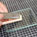 Lissoir en verre trempé, outil robuste pour polir et lisser, avec surface en verre résistant, conçu pour un usage professionnel.